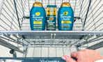 hand pushing a walgreens shopping cart with OGX progrowth hair care products