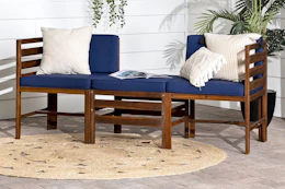 Lifestyle image of the Walker Edison Modern Acacia Patio Sofa Set in navy