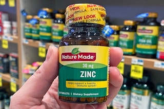 hand holding a bottle of nature made zinc