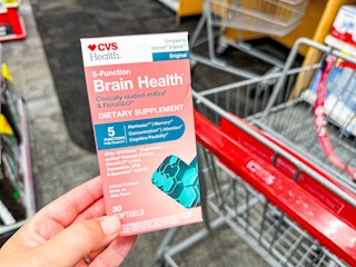 hand holding a box of cvs health brain health supplement