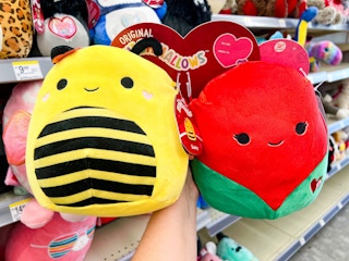 Someone holding up a Valentine's Day set of Squishmallows in Walgreens