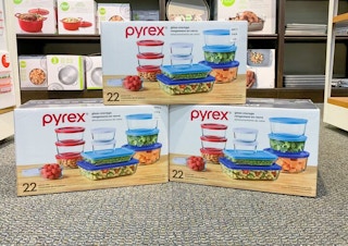 three pyrex boxes displayed on the floor