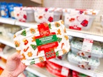 hand holding a cwc holiday food storage set in front of a target shelf