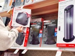 hand holding a honeywell space heater next to more on target shelf