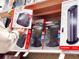 hand holding a honeywell space heater next to more on target shelf