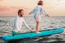 Lifestyle image of the FitRX Paddle Board being used by a father teaching his child how to SUP
