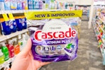 person holding a bag of cascade dishwasher pods