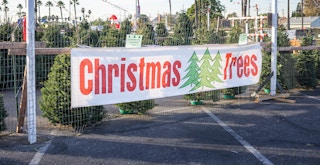 a christmas tree sign for a tree lot in parking lot