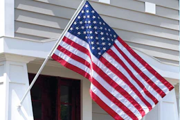 American flag hanging outside of house