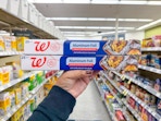 hand holding walgreens aluminum foil packs in store