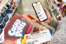 someone holding cereal, phone open to kcl, and coupon