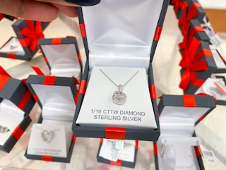 hand holding jewelry in a box