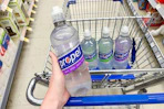 hand holding up a bottle of propel water
