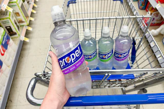 hand holding up a bottle of propel water