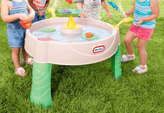 kids surrounding a Little Tikes water table