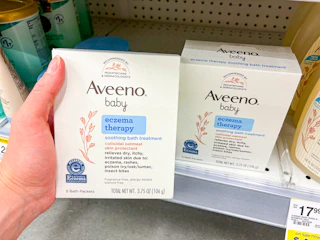 hand holding aveeno bath treatment in walgreens