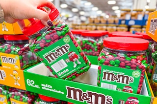 hand holding a jar of m&ms christmas candy