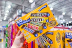 hand holding a box of mars candy bars