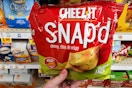hand holding a bag of cheez it snap'dcracker chips at kroger