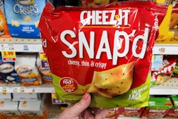 hand holding a bag of cheez it snap'dcracker chips at kroger