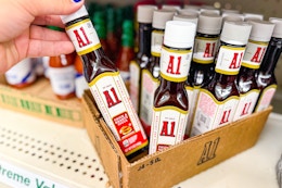 hand picking up a bottle of a.1. sauce at dollar tree