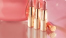 three gold lipstick tubes 