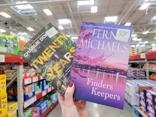 hand holding 2 books