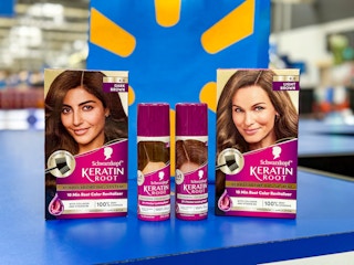 two boxes of schwarzkopf hair colors and 2 bottles of spray on walmart counter