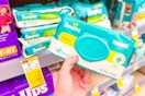 person holding a package of pampers baby wipes by the display