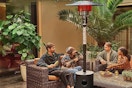 People sitting under patio heater. B0CC9KJMRM