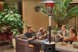 People sitting under patio heater. B0CC9KJMRM