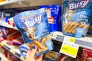 hand holding a bag of purina busy bone dog treats