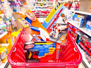 4 nerf blasters sitting in a target cart