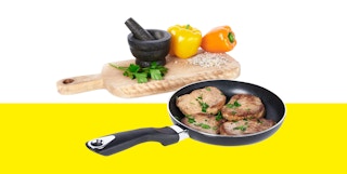 black nonstick pan with meat next to bell peppers on a cutting board