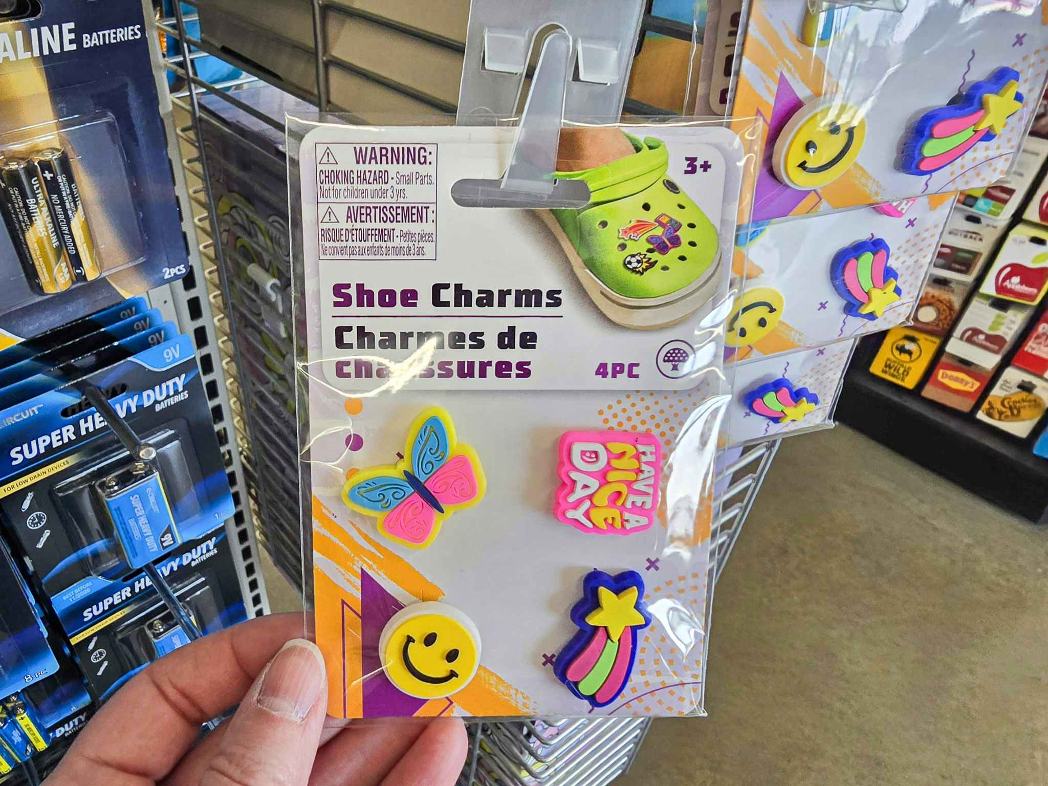 person grabbing a 4-pack of shoe charms