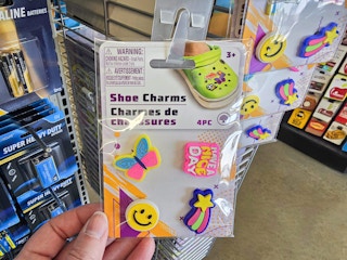 person grabbing a 4-pack of shoe charms