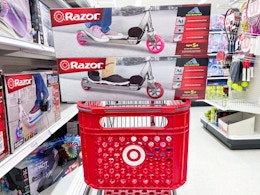 2 razor a kick scooters sitting on top a target cart