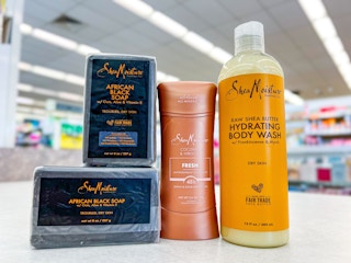 two bars of soap, body wash, and deodorant on store counter