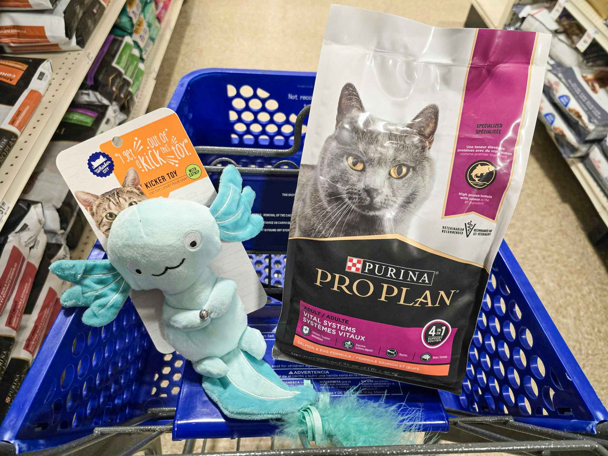bag of purina pro plan cat food and a cat toy in a cart