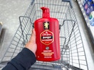 hand holding old spice body wash over walgreens cart