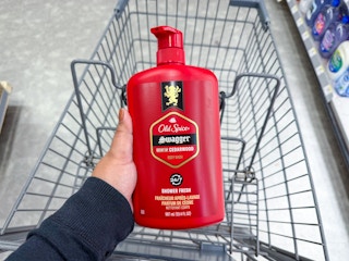hand holding old spice body wash over walgreens cart