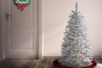 a prelit christmas tree near a door