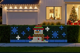 SmartDawn Smart Christmas Net Lights on a bush hedge during winter.