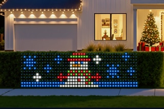 SmartDawn Smart Christmas Net Lights on a bush hedge during winter.