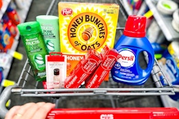 garnier shampoo, sally hansen hard as nails, colgate toothpaste, honey bunches of oats cereal, and persil detergent in a cart
