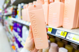 hand holding monday leave in conditioner