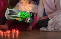a family holding a glowing football in a package