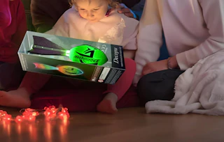a family holding a glowing football in a package