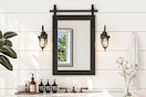 Lifestyle image of a farmhouse style accent mirror in bathroom setting