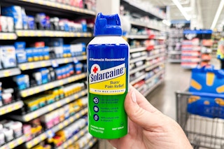 Solarcaine Spray in a Walmart aisle with blue Walmart reusable bag in the background